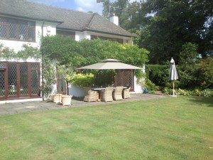 Taupe side arm parasol over garden dining table