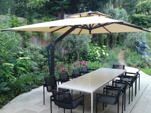 Contemporary garden parasol standing over garden furniture