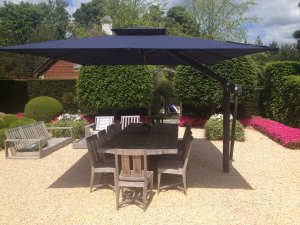Cantilever parasol with dark blue canopy and in-ground base